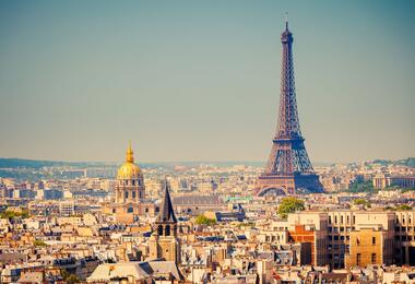 Panoramic view of Paris featuring the Eiffel Tower amidst a vibrant cityscape.