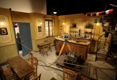 A film set featuring a bar, chairs, and tables