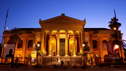 A large building featuring classical columns, showcasing architectural elegance and grandeur.