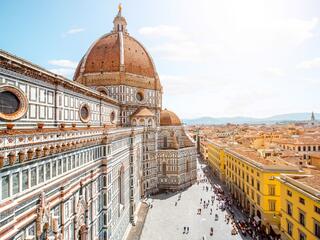 Panoramic view from the top of Florence's Duomo, showcasing the city's historic architecture and rolling hills.