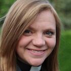 Reverend Kate Bottley, a Church of England vicar, smiles while wearing a clerical collar