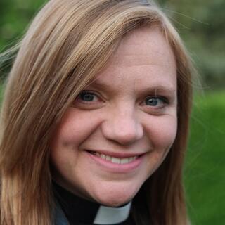 Reverend Kate Bottley, a Church of England vicar, smiles while wearing a clerical collar