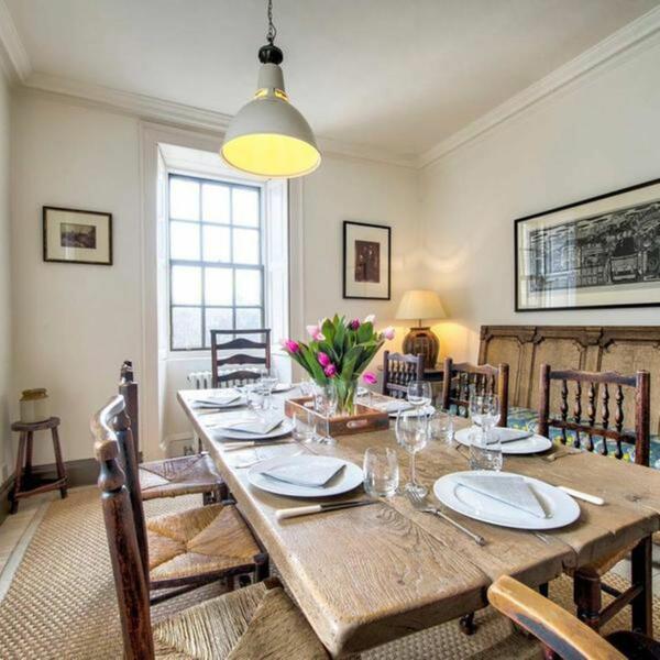 laid wooden dining table with chairs