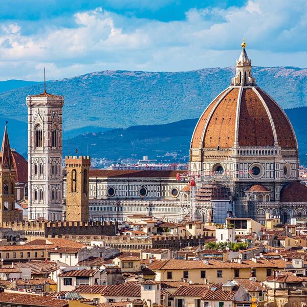 A panoramic view of Florence, Italy, showcasing the iconic cathedral and surrounding historic architecture.
