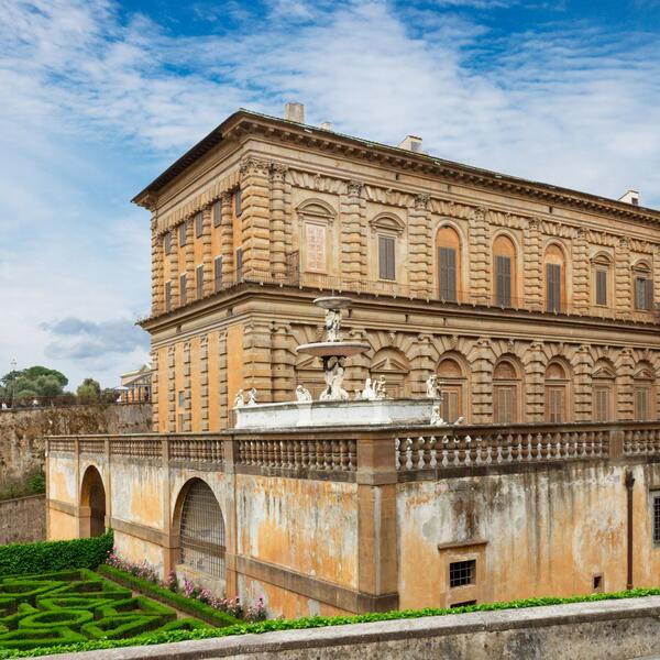 Scenic view of the Boboli Gardens with the Viceroy's Palace in the background, showcasing lush greenery and elegant architecture.