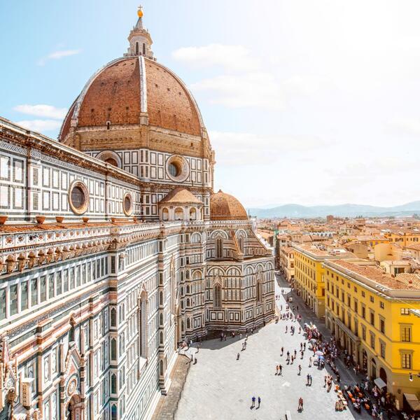 Panoramic view from the top of Florence's Duomo, showcasing the city's historic architecture and rolling hills.