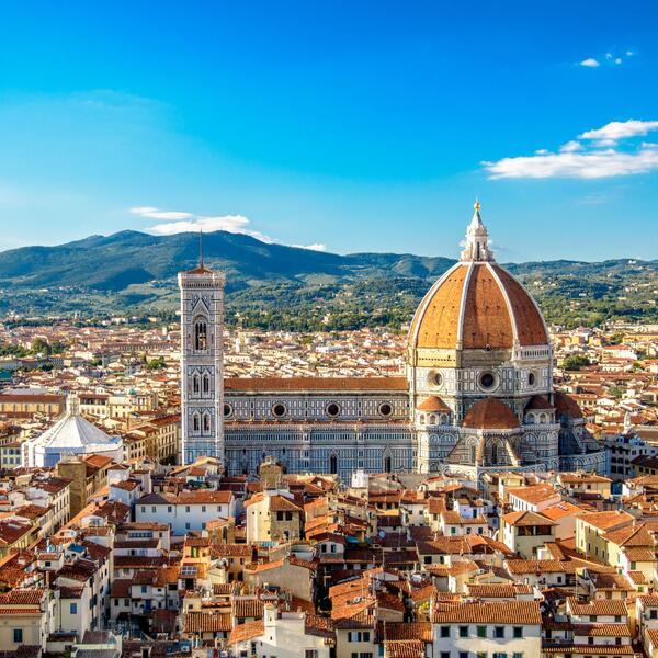 The magnificent Duomo of Florence, featuring its distinctive dome and detailed architecture, set in the heart of the city.