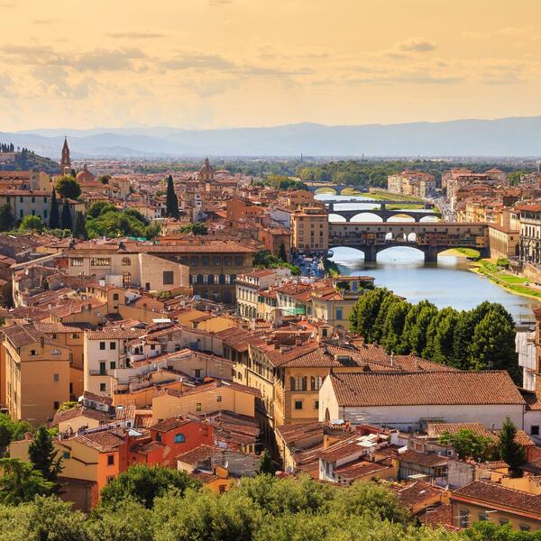 Panoramic view of Florence showcasing historic buildings and the iconic Duomo against a clear blue sky.