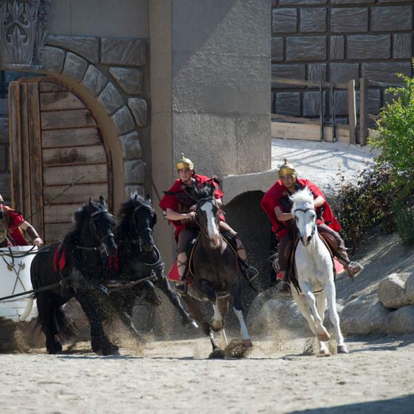 A group of individuals on horseback, dressed in historical costumes, participating in the Sordevolo Passion Play.