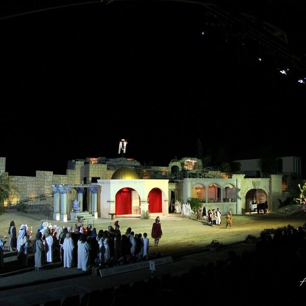 Scene from the Sordevolo Passion Play with a stage adorned for the performance and actors dressed in period costumes.