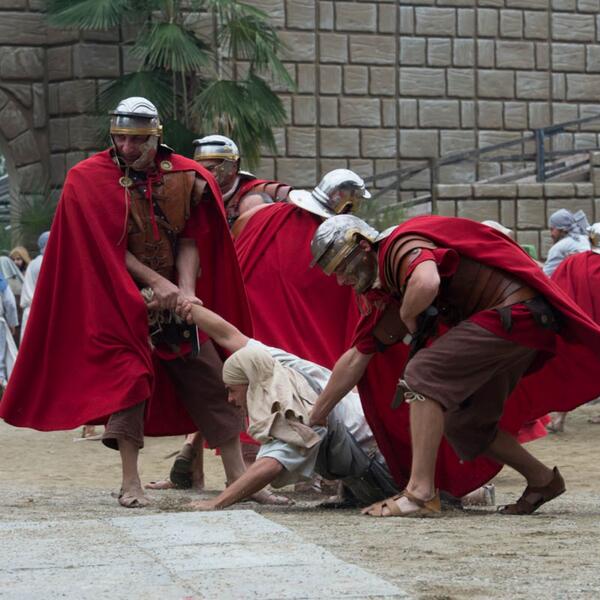 A group of men in Roman armor, portraying characters from the Sordevolo Passion Play, standing together in a dramatic pose.
