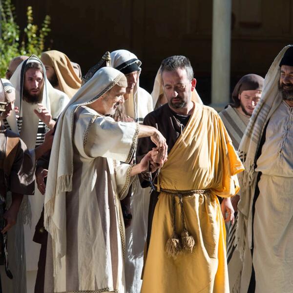 Ensemble of actors dressed in religious garments, depicting a scene from the Sordevolo Passion Play.
