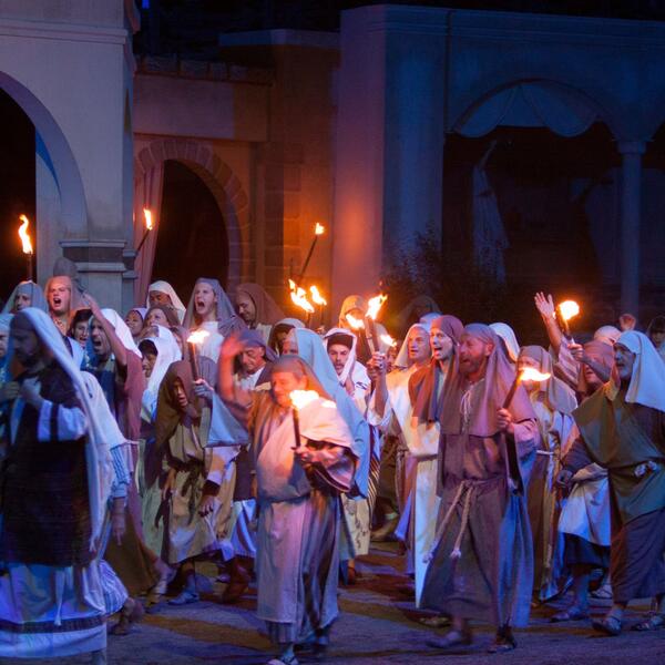 Actors in traditional attire, engaged in a dramatic performance of the Sordevolo Passion Play.