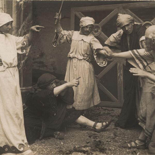 A group of actors in historical costumes performing a scene from the Sordevolo Passion Play.