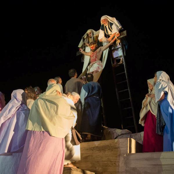 Jesus is crucified in a nativity scene, surrounded by figures depicting the Passion Play in Sordevolo.