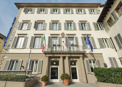Exterior view of Hotel Executive Florence, showcasing its elegant architecture and welcoming entrance.